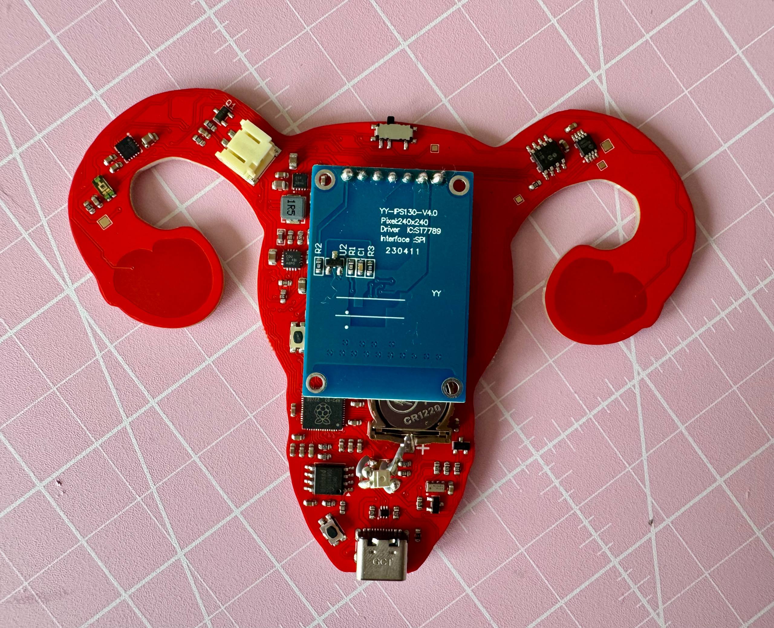 Back side of the Clotty PCB showing the display module, battery connector, RTC backup battery, and supporting circuitry