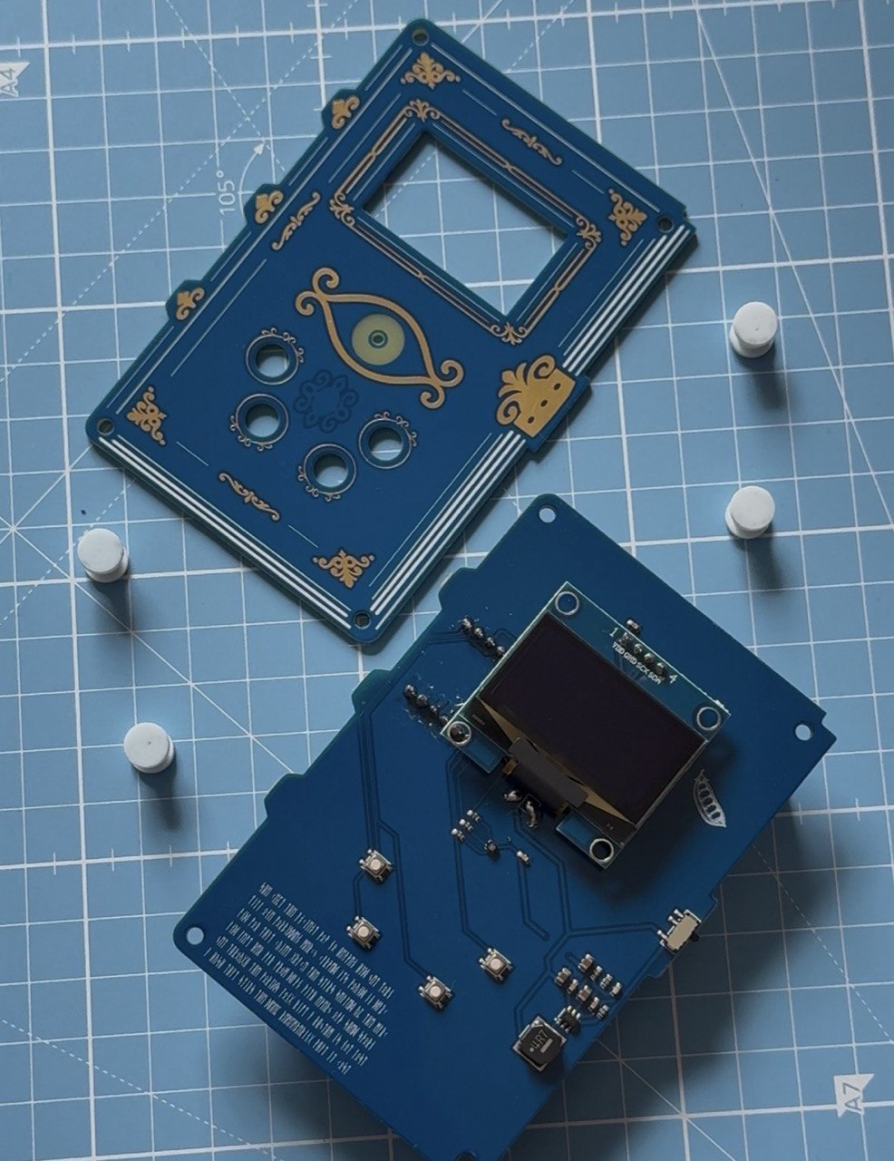 The Spell Tome taken apart, showing the decorative front PCB, carrier PCB, OLED display and buttons
